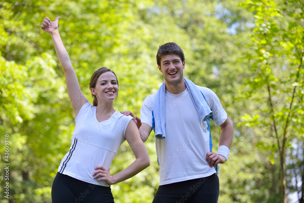 Couple doing stretching exercise after jogging Couple doing stretching exercise after jogging
