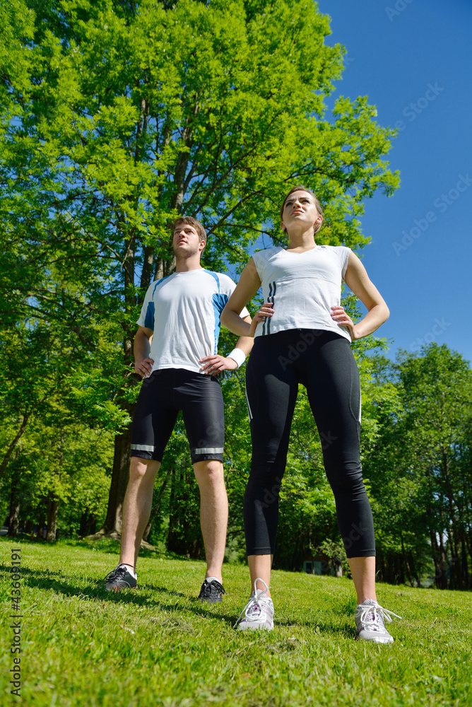 Couple doing stretching exercise after jogging Couple doing stretching exercise after jogging