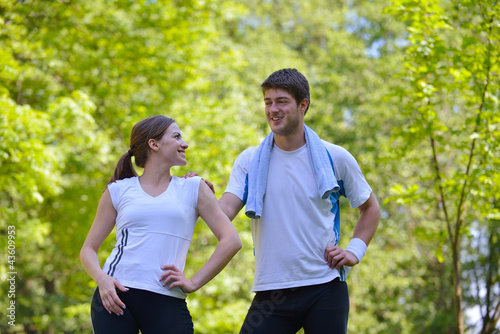 Fototapeta Naklejka Na Ścianę i Meble -  Couple doing stretching exercise  after jogging