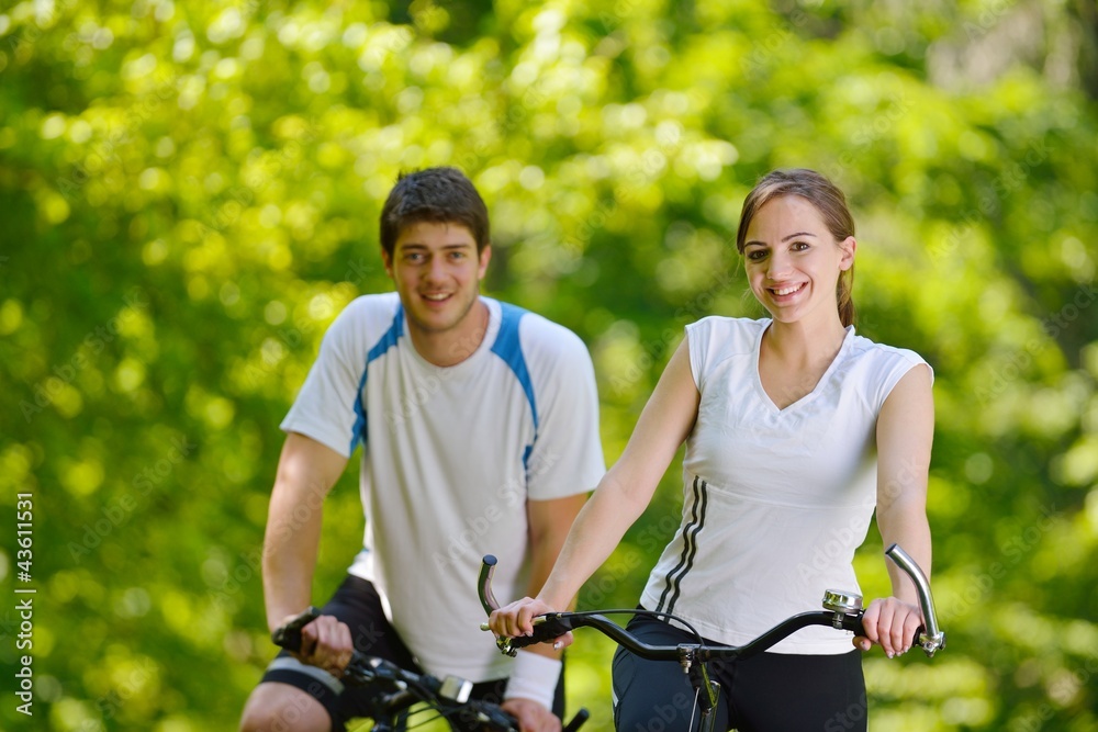 Fototapeta premium Happy couple riding bicycle outdoors