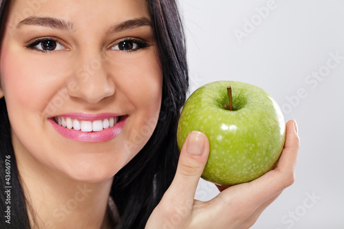 Young smiling woman with apple
