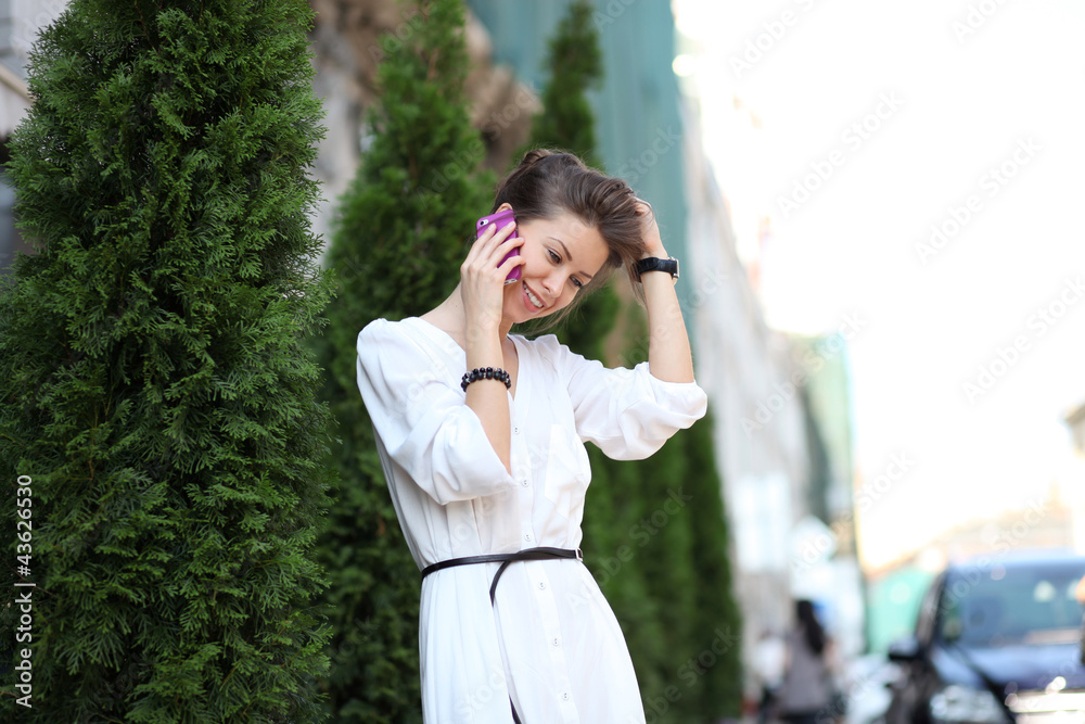 portrait of young woman talking on mobile phone portrait of young woman talking on mobile phone