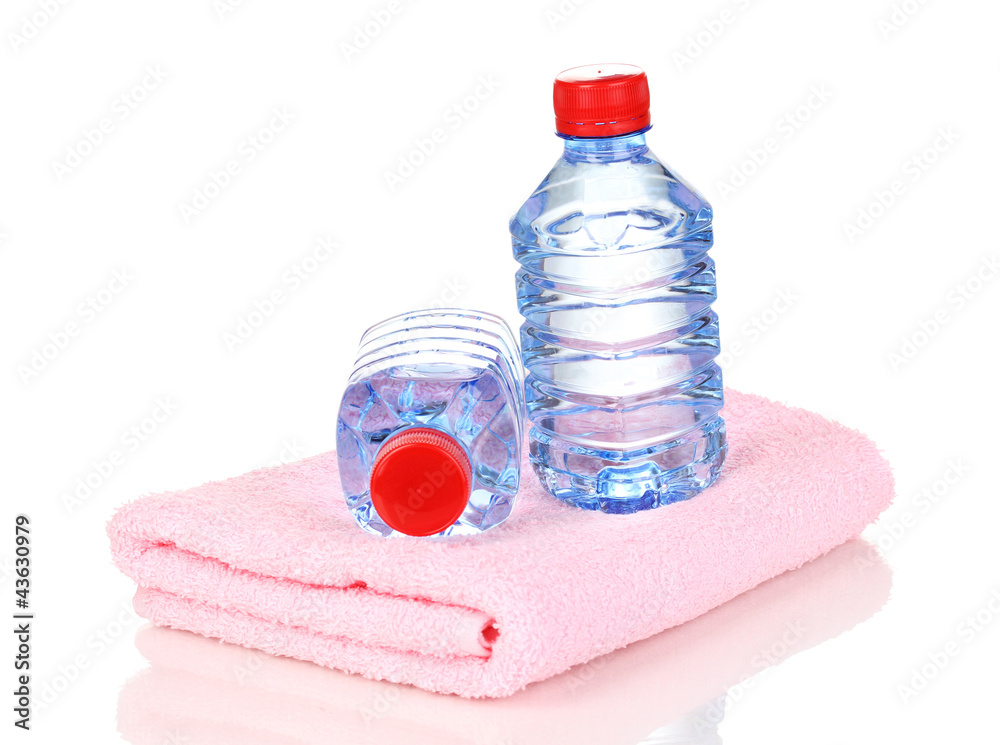 Fototapeta premium plastic bottles of water on towel isolated on white