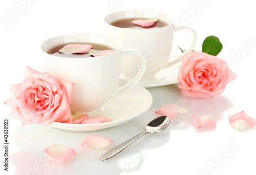 cups of tea with roses isolated on white