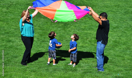 фотографія Family Playing with Parachute in a Park