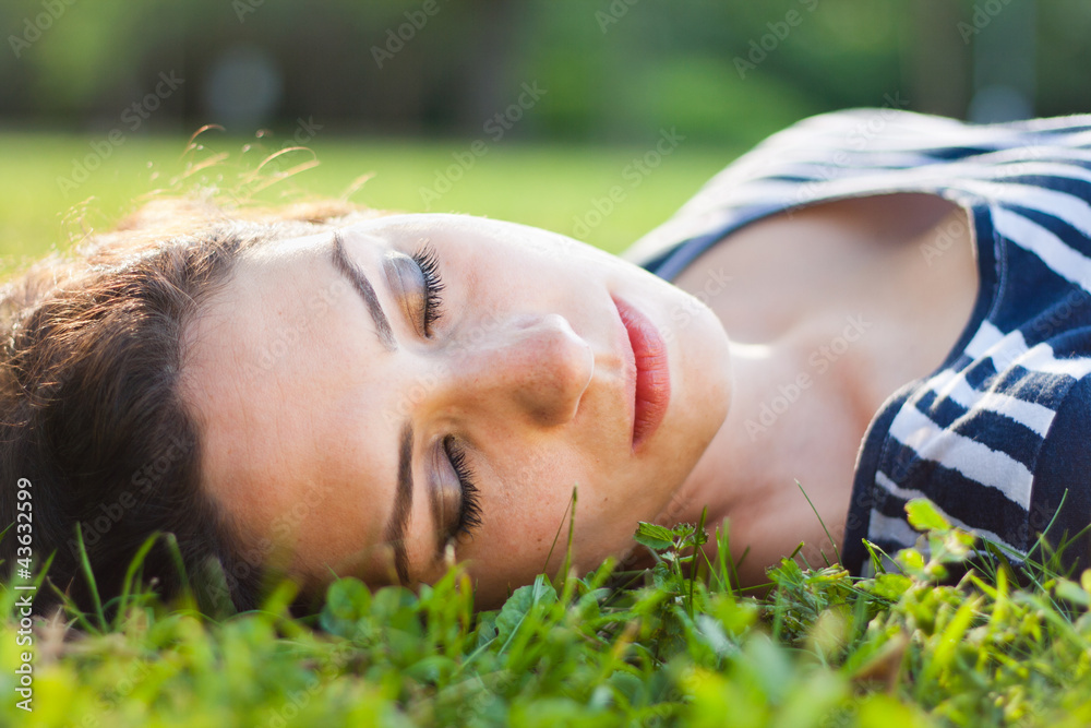Closeup of a beautiful young woman sleeping in grass Closeup of a beautiful young woman sleeping in grass
