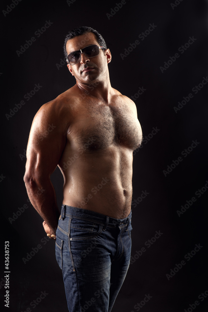 Fototapeta premium portrait of topless athletic man posing over black background