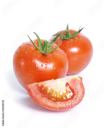 Tomatoes with water drops on the white