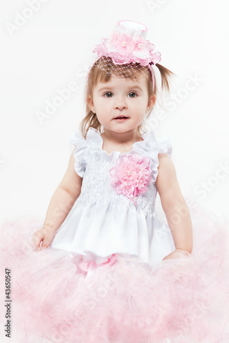 Portrait of a young girl in beautiful pink dress
