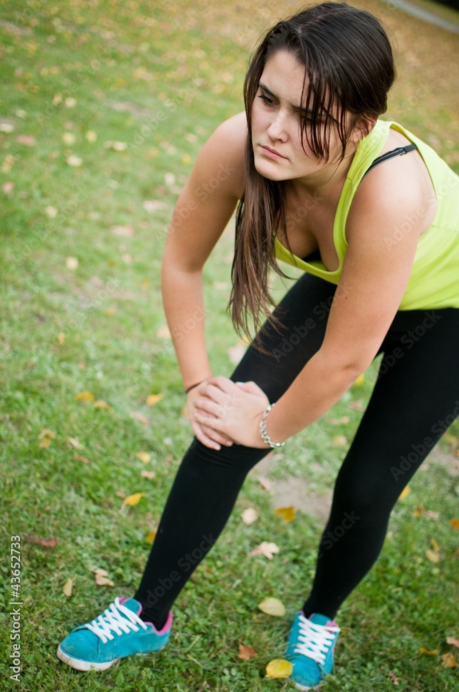 Knee injury - woman in pain after sport Knee injury - woman in pain after sport