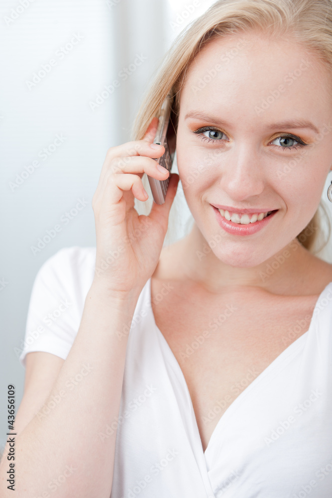 Closeup portrait of a happyblond woman speaking on a cellphone Closeup portrait of a happyblond woman speaking on a cellphone