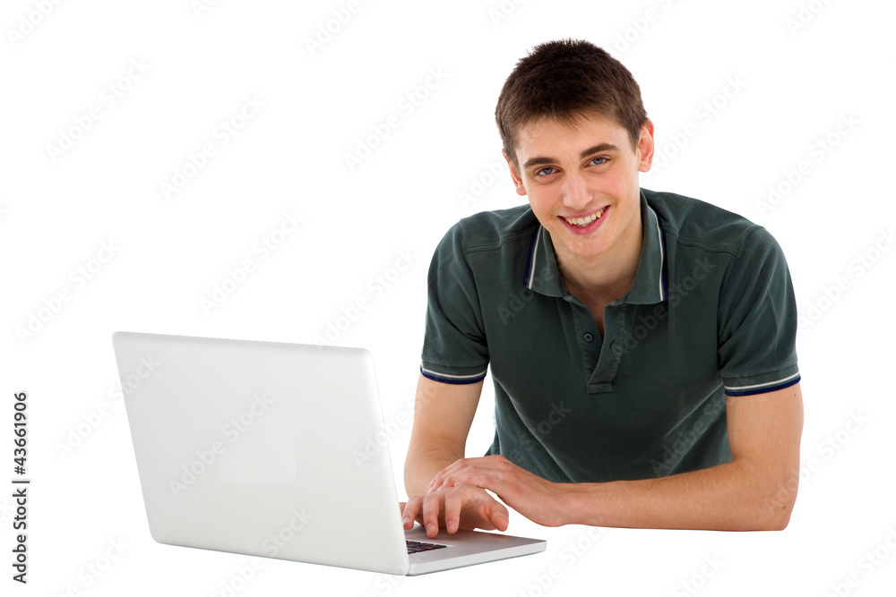 teenage boy with laptop lying down