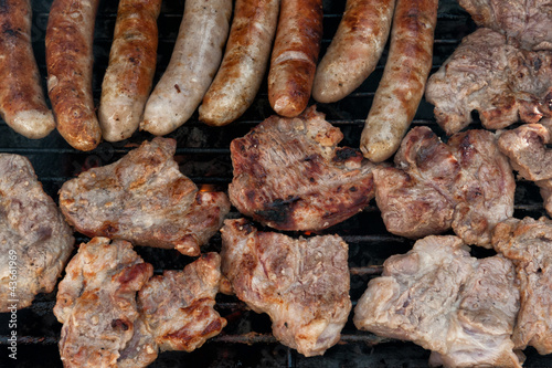 Assorted meat cooking on a barbeque