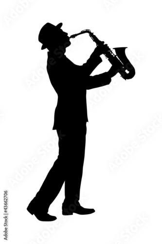 A silhouette of a full length portrait of a man in a suit playin
