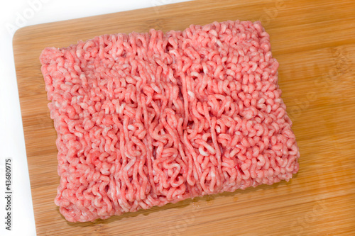 minced meat on a wooded cutting board