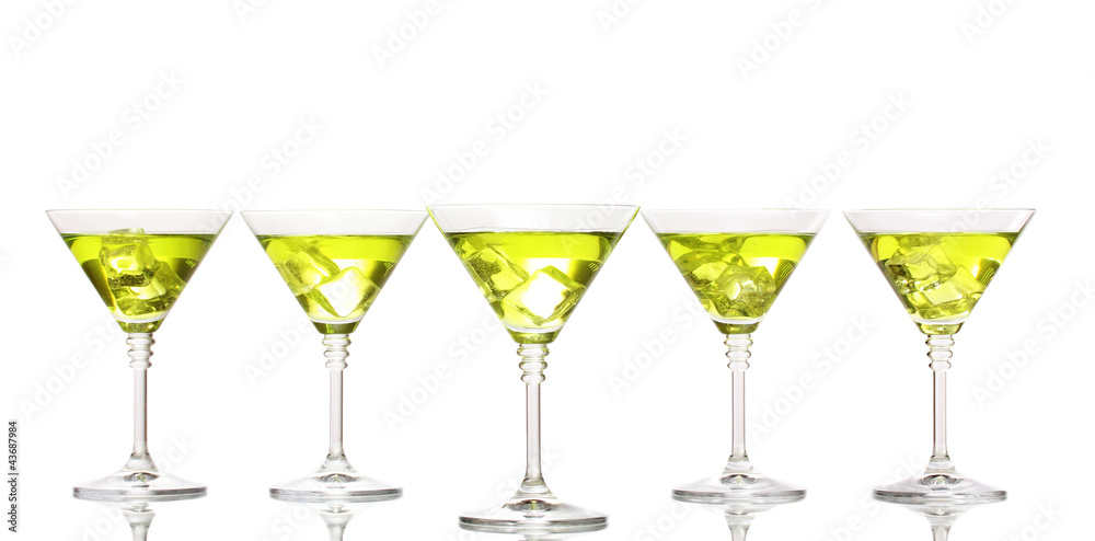 Yellow cocktail in martini glasses isolated on white