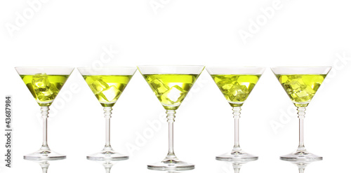 Yellow cocktail in martini glasses isolated on white