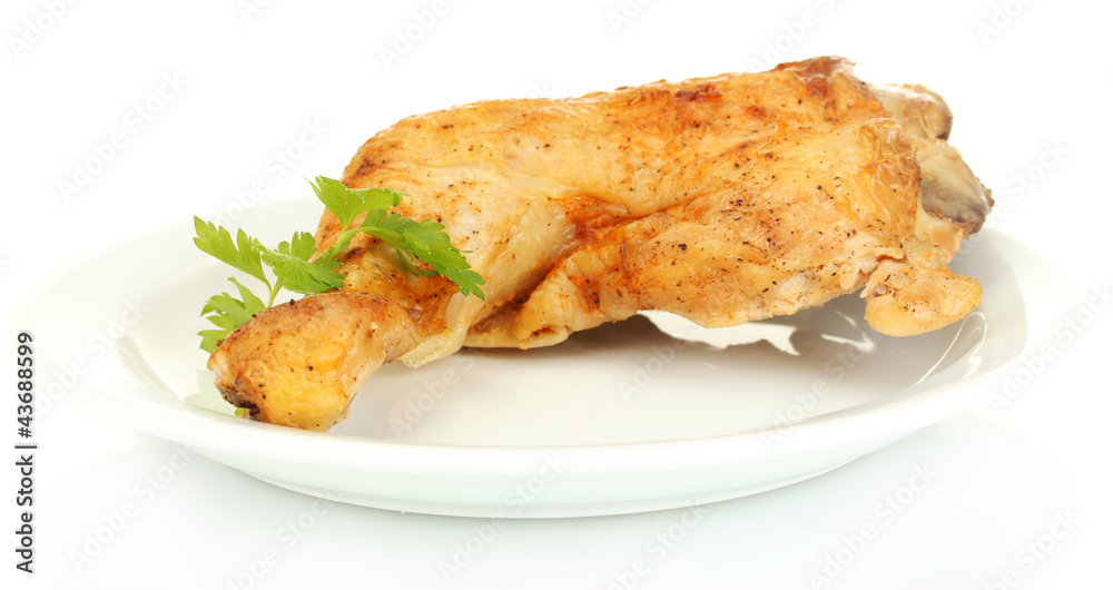 roasted chicken leg with parsley in the plate isolated on white