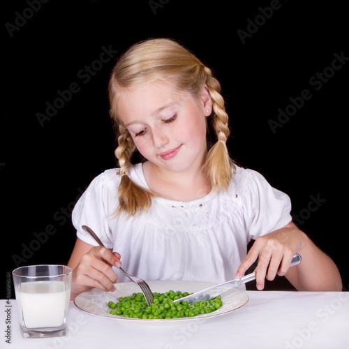 Girl eating peas