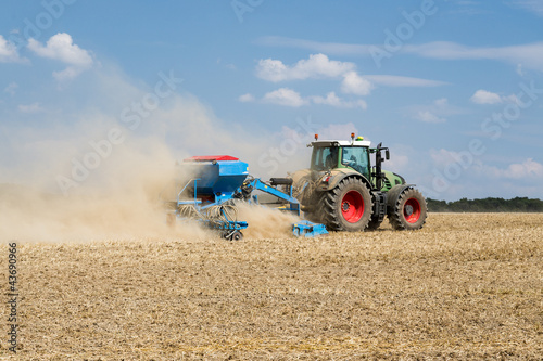 Tractor with a sowing machine working in the field