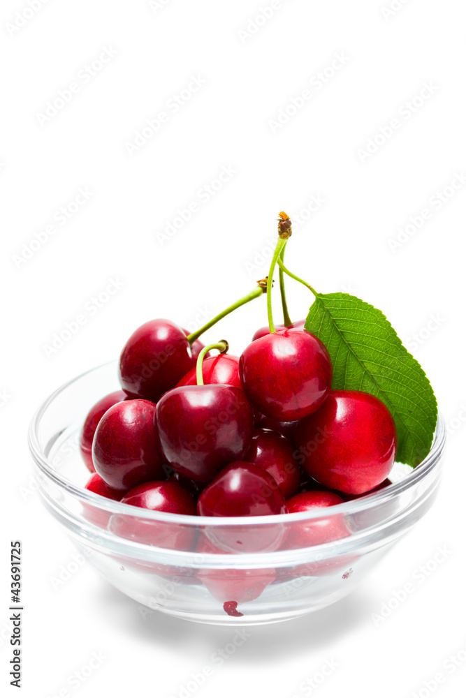 cherries on glass bowl isolated on white background cherries on glass bowl isolated on white background