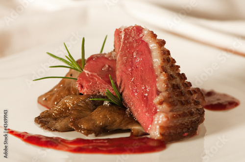 Duck breast with raspberry sauce and mushrooms