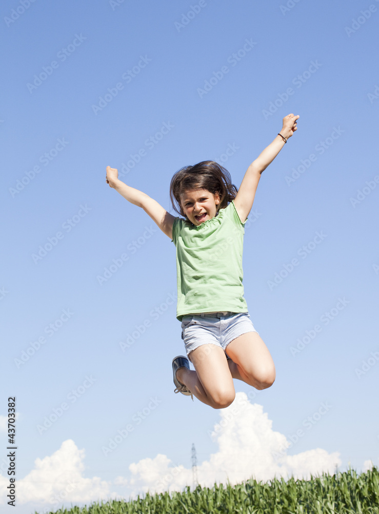 excited young girl jumping in the air excited young girl jumping in the air