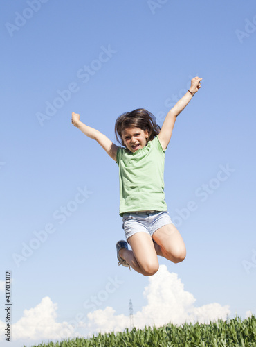excited young girl jumping in the air