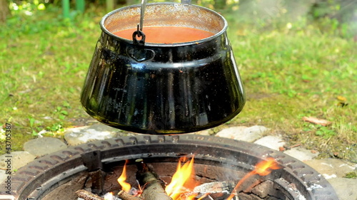 pot of goulash cooking over the campfire photo