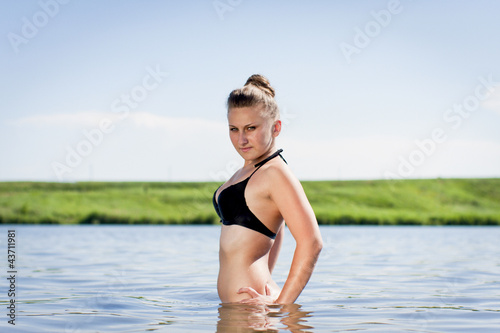 beautiful young woman bathing in a lake
