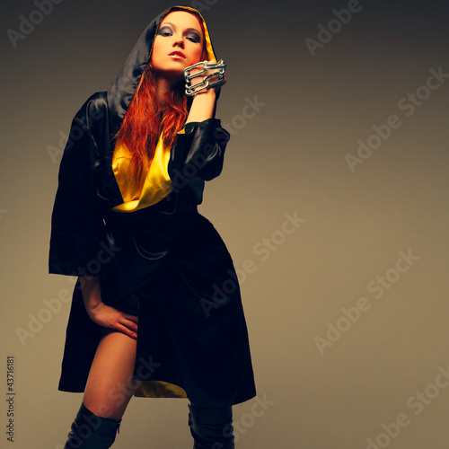 A beautiful young woman is in dark  clothes photo