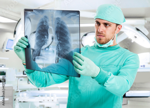 Surgeon examining a radiography