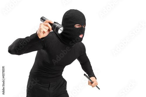 A thief holding a flashlight and piece of pipe Fototapet