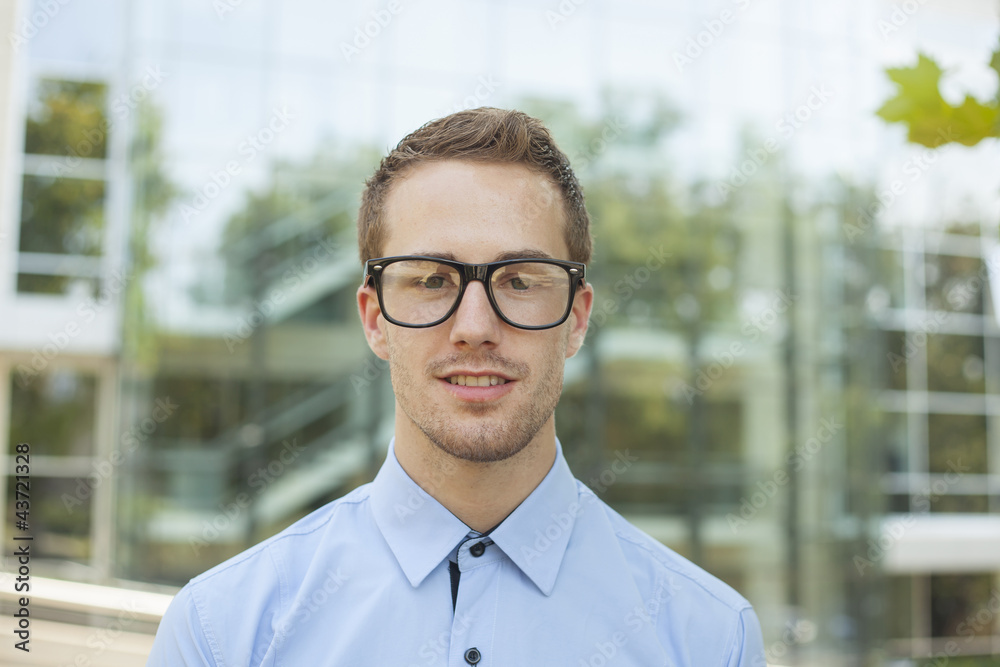Businessman in front of business building Businessman in front of business building