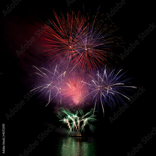 Firework over the water in the night sky