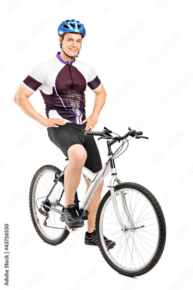 Full length portrait of a smiling bicyclist posing on a bicycle Full length portrait of a smiling bicyclist posing on a bicycle