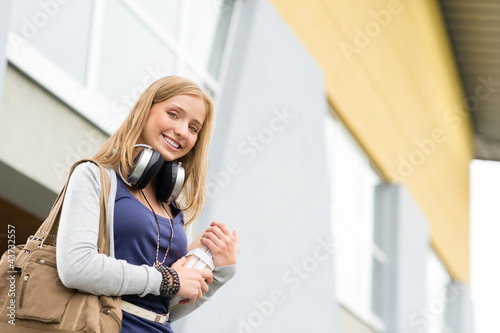 Canvas Print Student carrying books to school headphones young