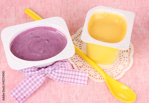 Yogurts with banana and blueberries close-up photo