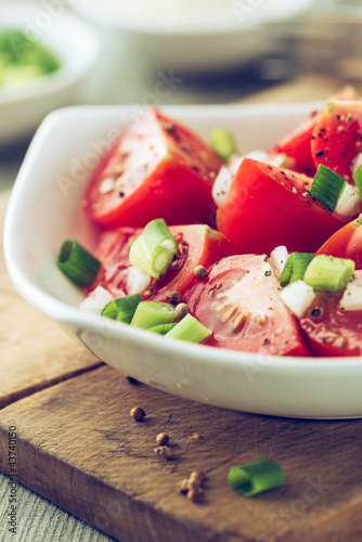 Tomato salad with spring onion and coriander seeds