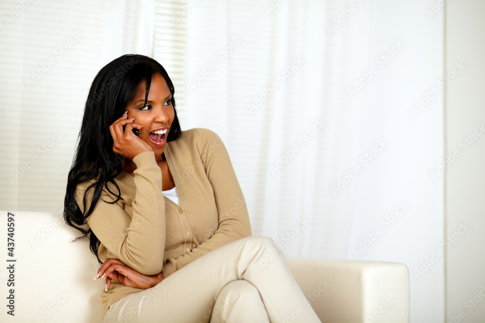 Happy and surprised woman talking on cellphone Happy and surprised woman talking on cellphone