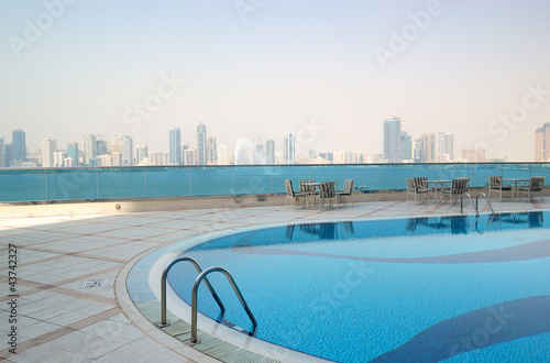 Swimming pool with Sharjah fountain and man-made lake view at th