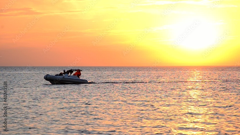 Boat floats on a sea at sunset.Original video without processing Boat floats on a sea at sunset.Original video without processing