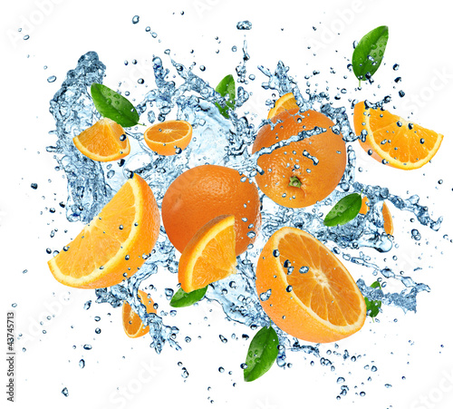 Fresh oranges in water splash on white background.