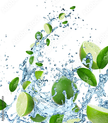 Fresh limes in water splash