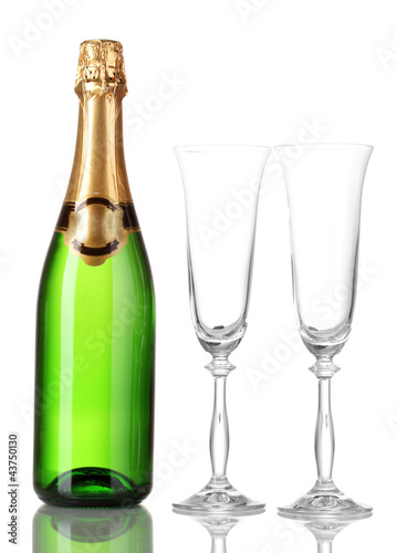 Bottle of champagne and goblets isolated on white.