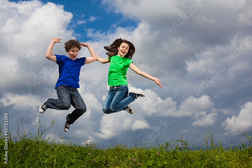 Girl and boy running  jumping outdoor