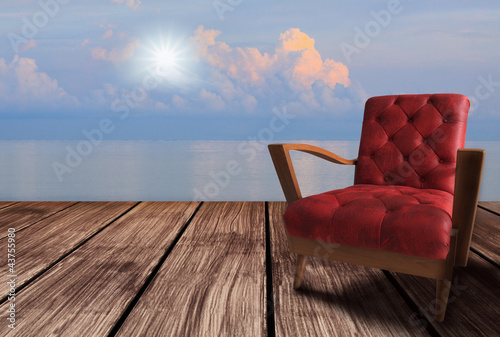 red  arm chairs on wood terrace and blue sky © stockphoto mania
