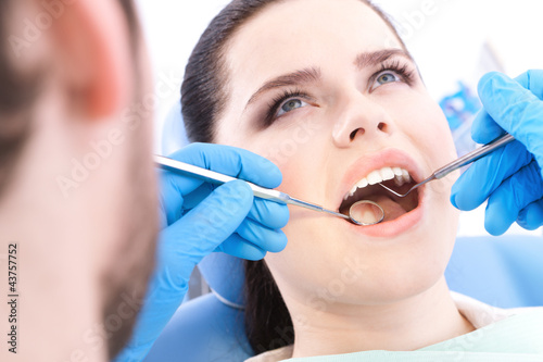 Dentist examines the teeth of the patient on the dentist s chair