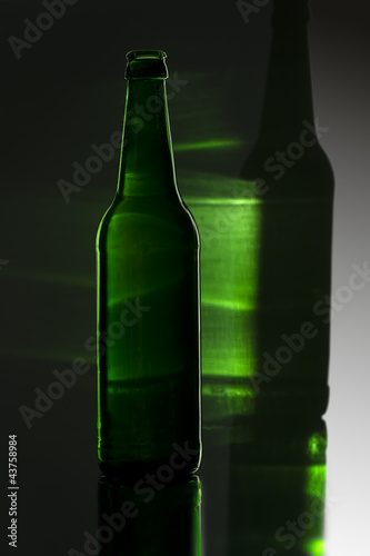 green bottle with colored reflection