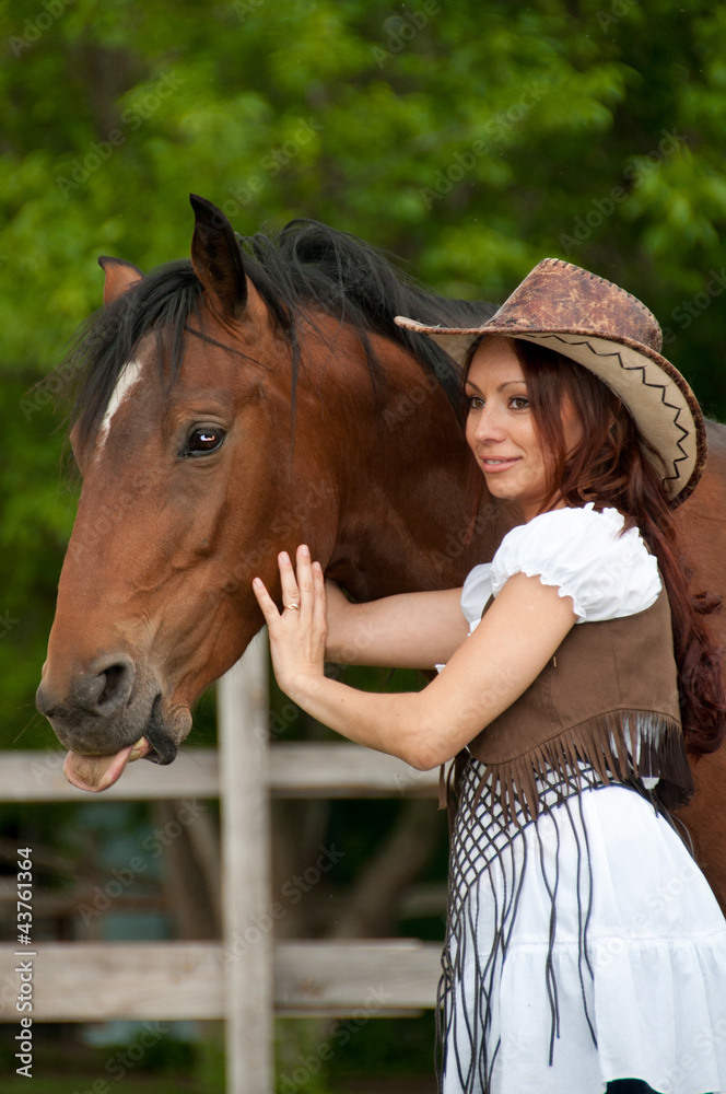A beautiful girl in a cowboy hat with a horse A beautiful girl in a cowboy hat with a horse